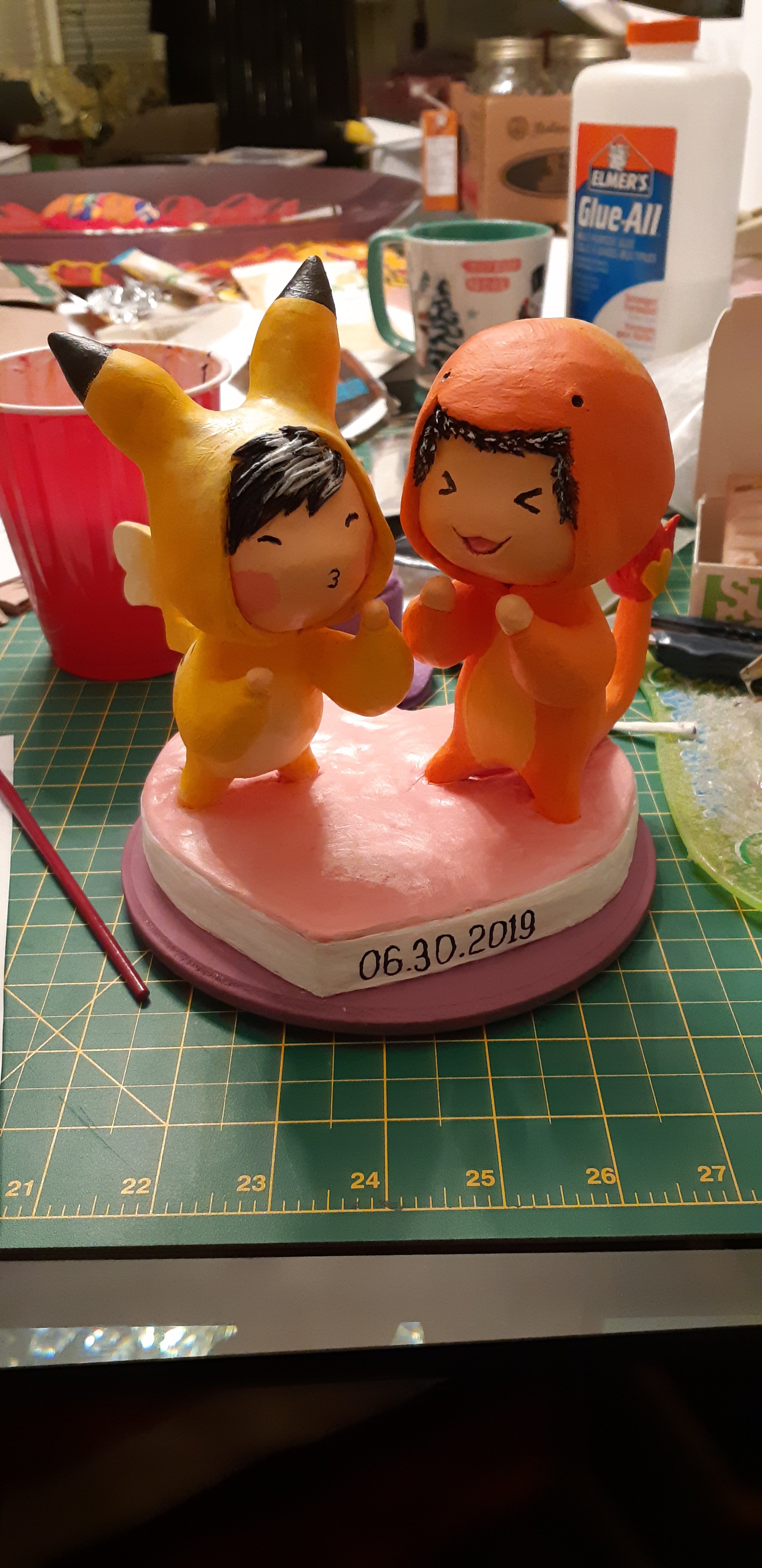 A work-in-progress photo, depicting the sculpts of the couple, painted with gouache-acryl paint. 