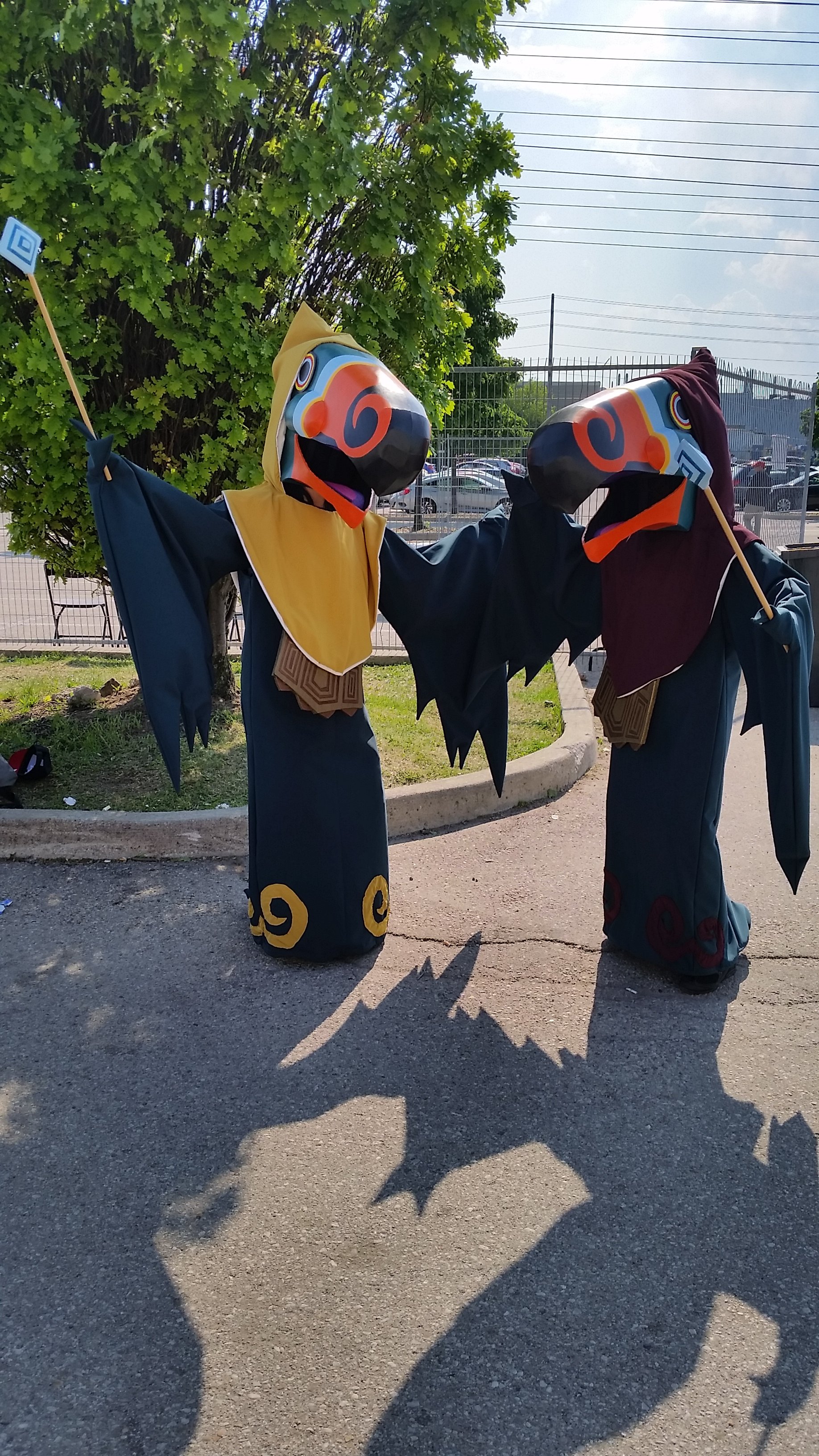 Two cosplays of the Wizzrobe enemies from The Legend of Zelda Wind Waker. They each have different hood colours - one in yellow and the other in maroon.
