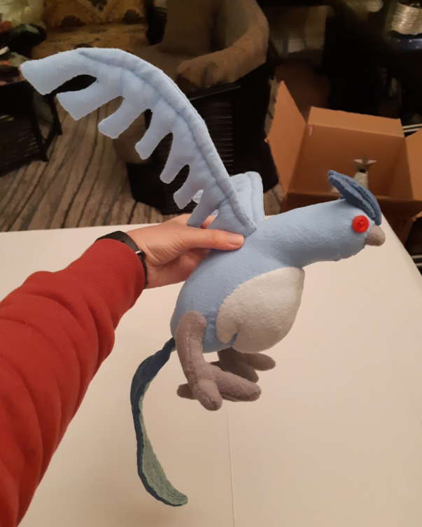 Side view of the new Articuno plush, with its wings held up.