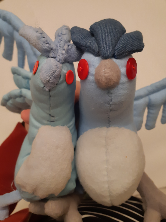Side-by-side comparison of the two Articuno plush, showing the Derpy looks they have when they are seen head-on.