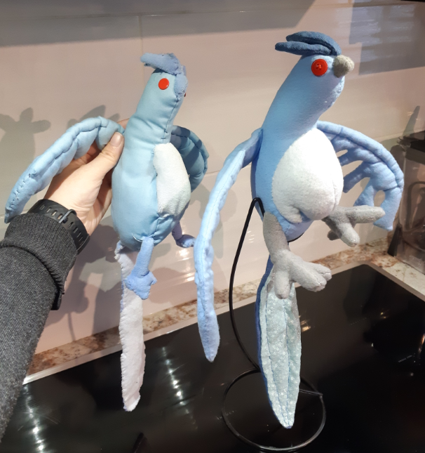 Side-by-side comparison of the two Articuno plush toys, taken from an angle.