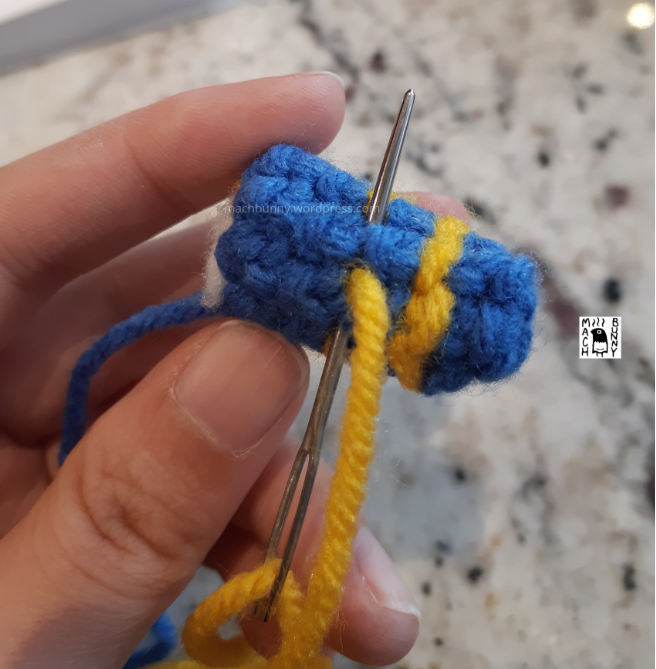 Amigurumi Luxio, with stripes being stitched onto the front legs