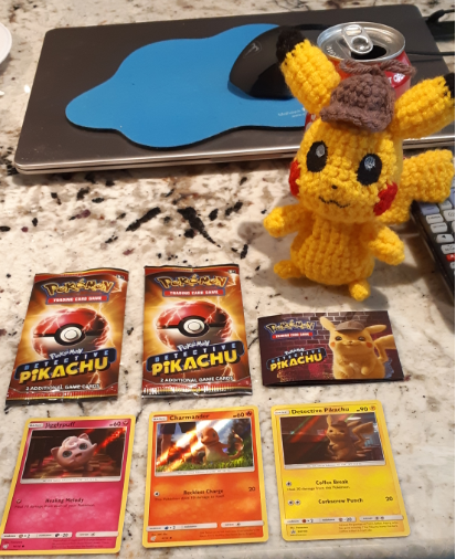 Amigurumi Detective Pikachu, front view with promo cards from the movie