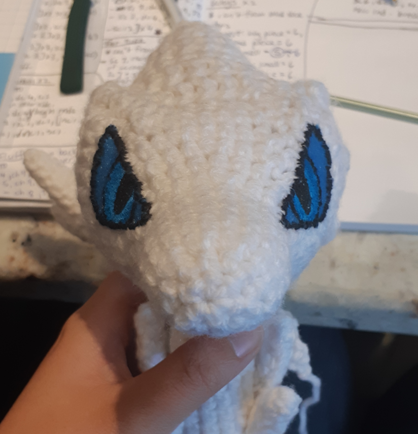 Amigurumi Reshiram, front view of face with eyes stitched on and painted