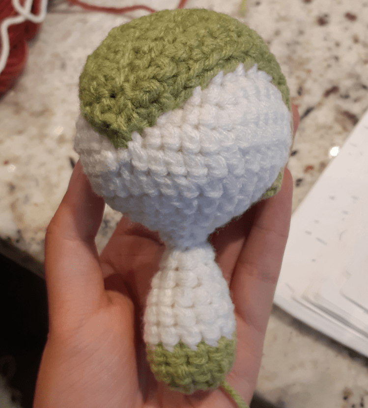 Bangs assembled onto the head and body piece of Kirlia amigurumi