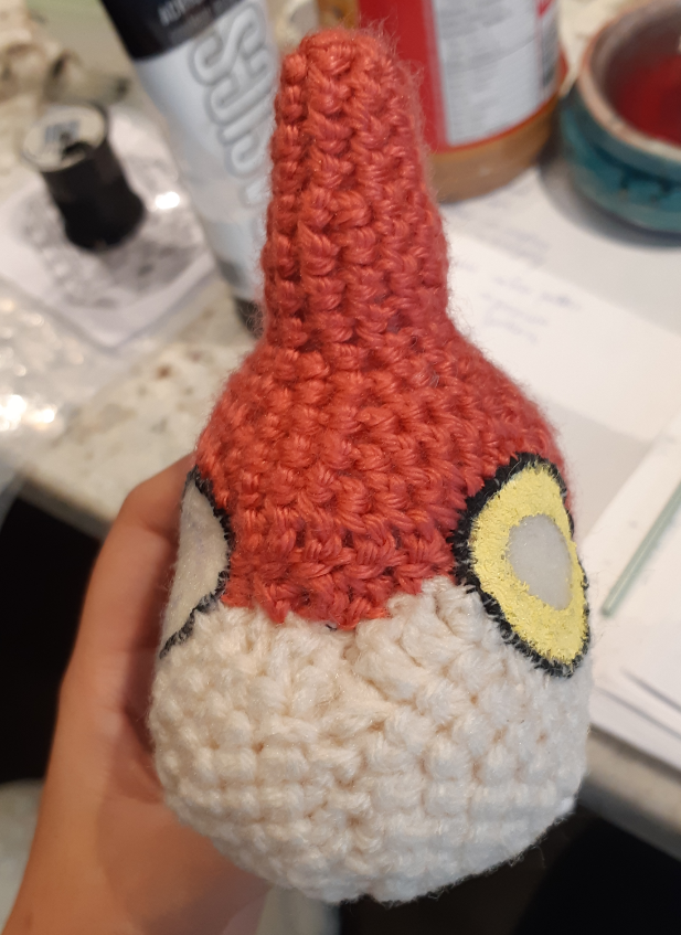 Amigurumi Wurmple, front view of face with partially painted eyes