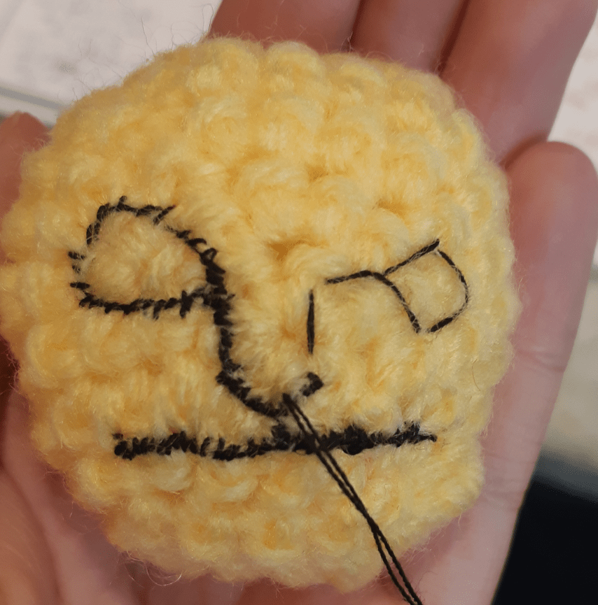 Amigurumi Yamask, front view of the mask being embroidered