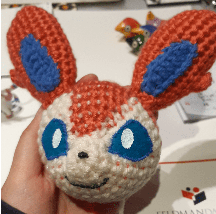 Amigurumi Sylveon, with head base stitched together with facial features
