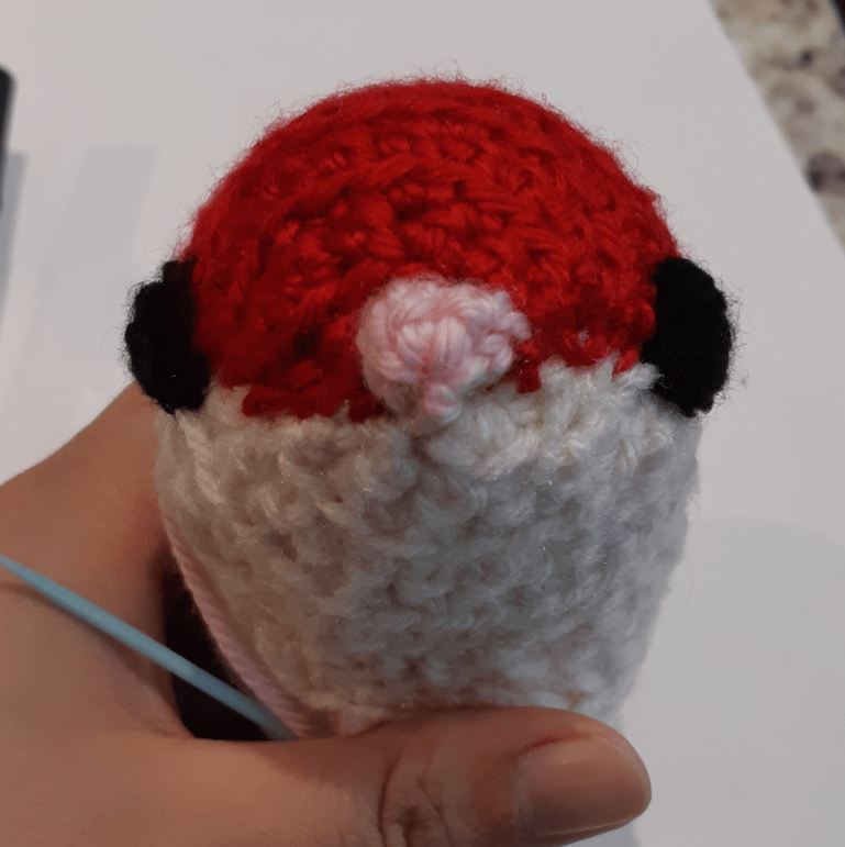 Amigurumi rat, front view of base body with eyes and nose attached