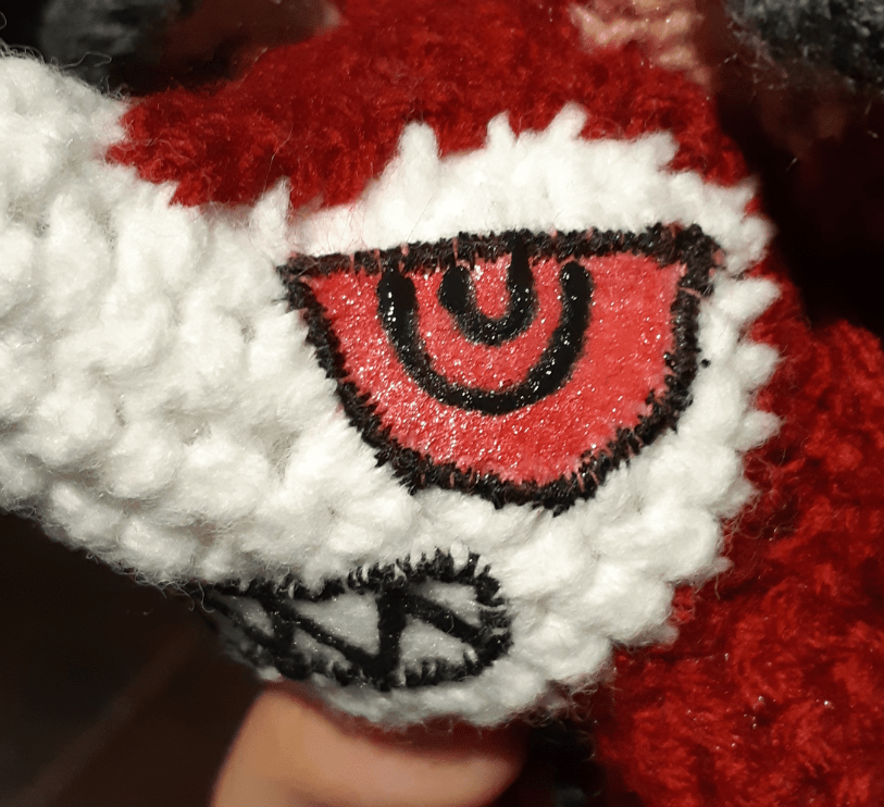 Amigurumi felt details: showing one eye painted and details added on top
