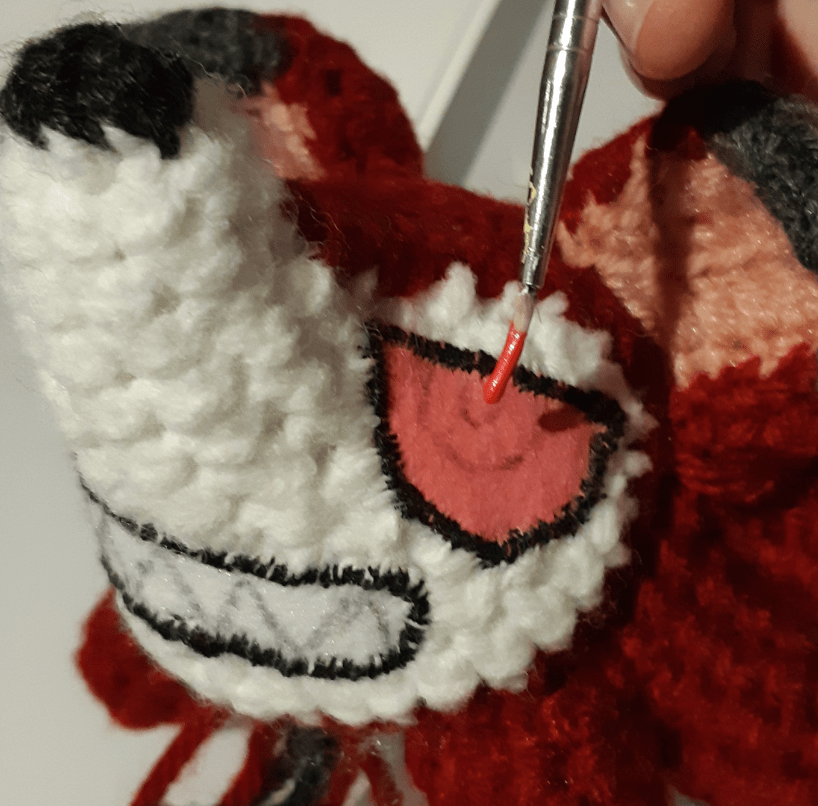 Paint is applied onto felt with a small paintbrush, or nozzle tip from a tube of fabric paint