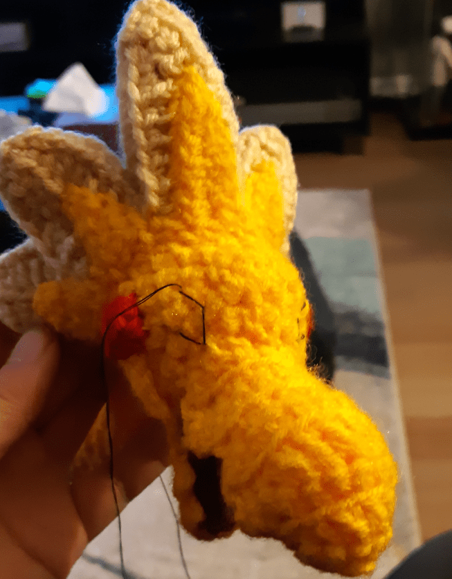 Amigurumi Velozolt, showing rough outline of embroidered eyes